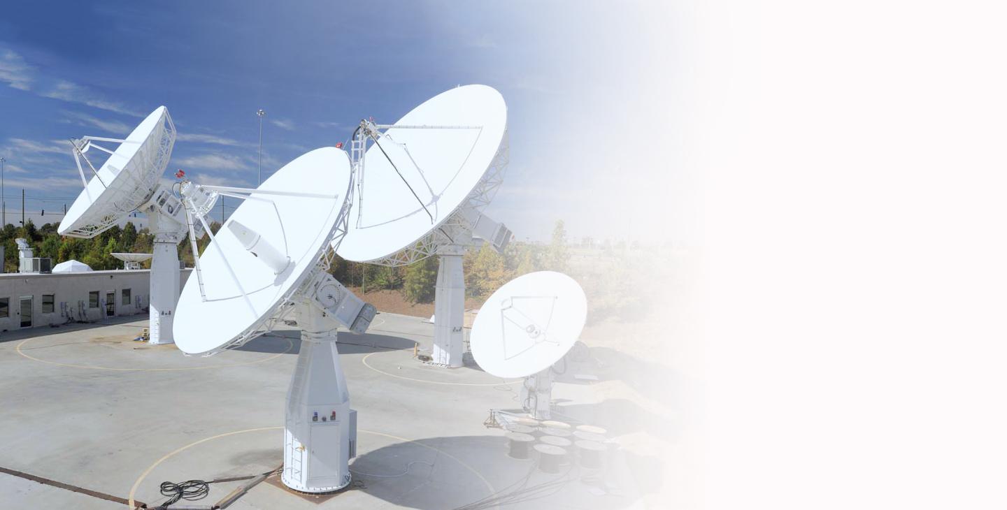 Four ground antennas pointed at the sky